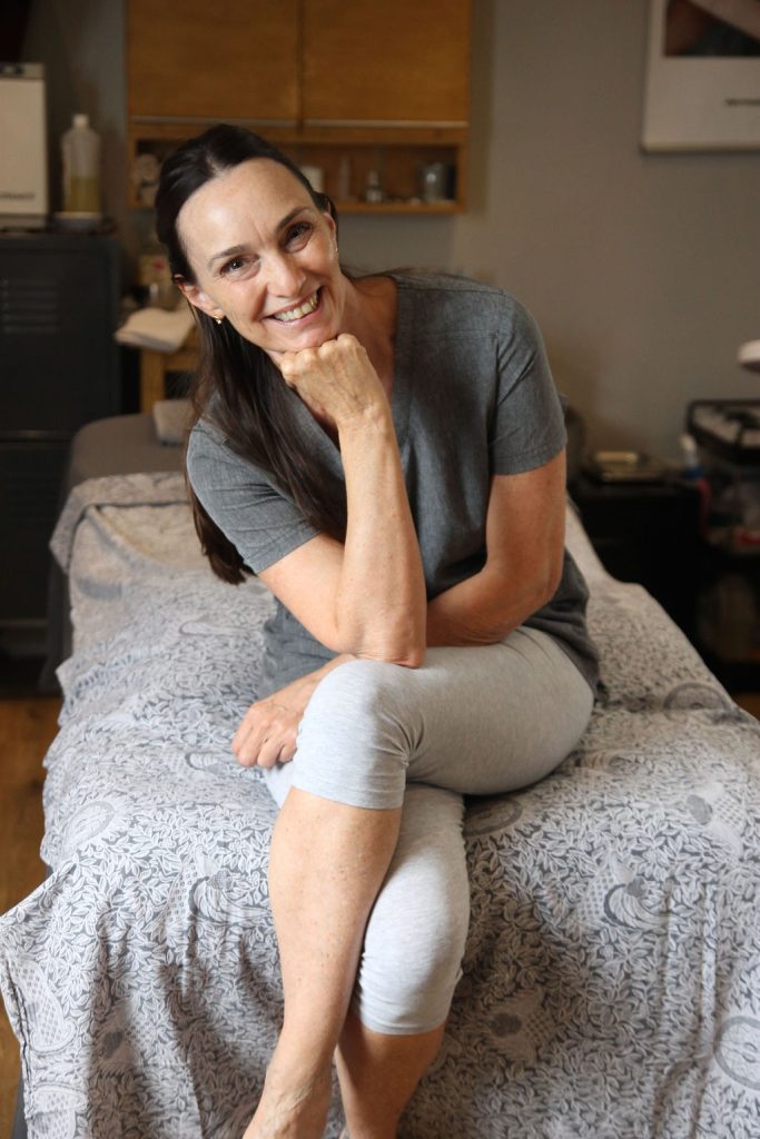 Ellie Harris seated on a treatment bed at Rituals